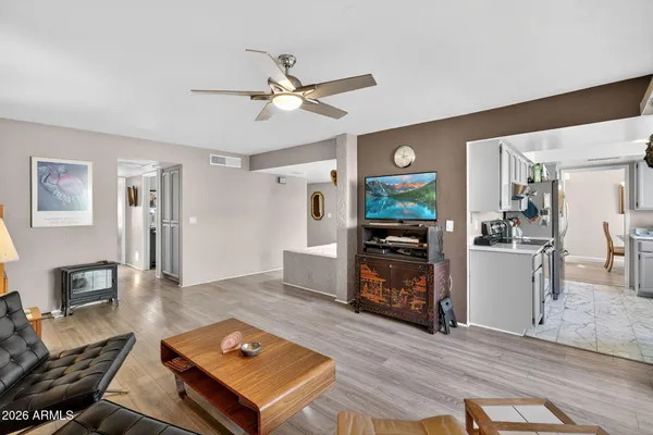 a living room with furniture fireplace and flat screen tv