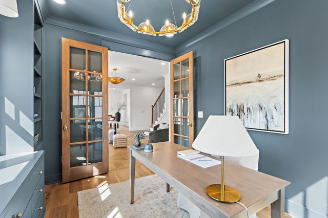 a living room with furniture a fireplace and a chandelier