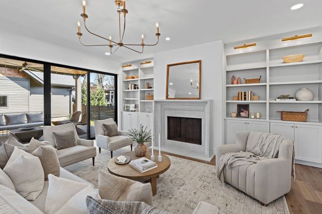 a kitchen with a table chairs stove and wooden floor