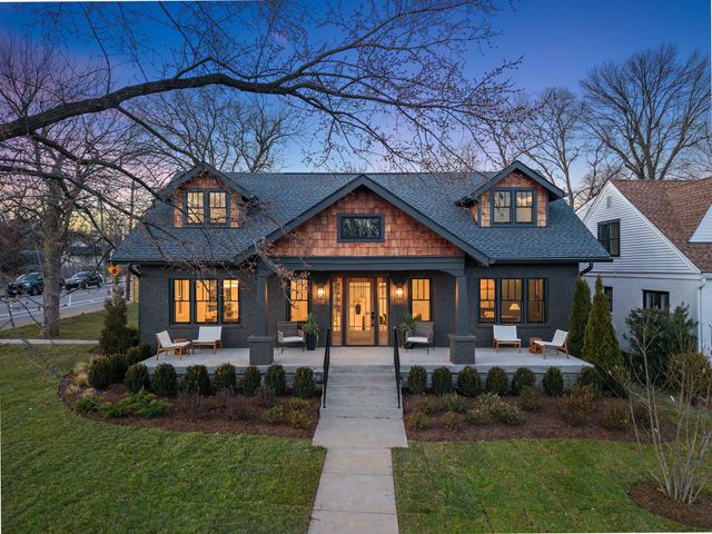 a front view of a house with a yard and outdoor seating