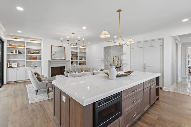 a spacious bathroom with double vanity sinks a large mirror and a bathtub