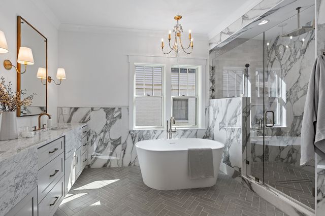 a view of an empty room with wooden floor and windows