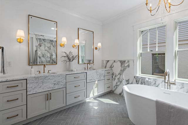 a bathroom with a double vanity sink toilet and mirror