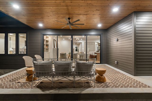 a dining room with furniture a chandelier and wooden floor