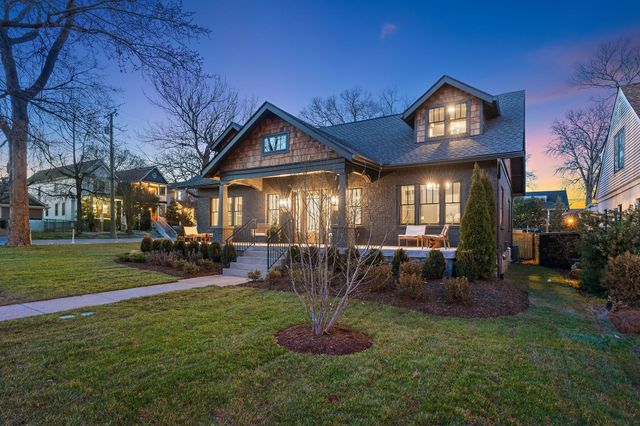 a view of a house with backyard porch and sitting area