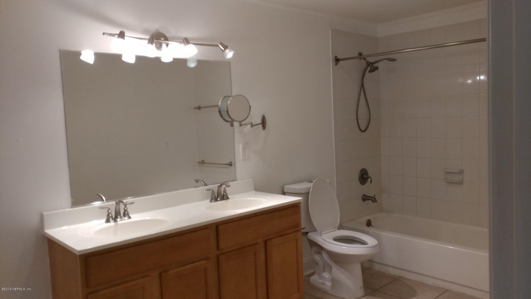 54102 Snyder Road Callahan, FL 32011 - Photo 11 of 14 a bathroom with a double vanity sink toilet and shower