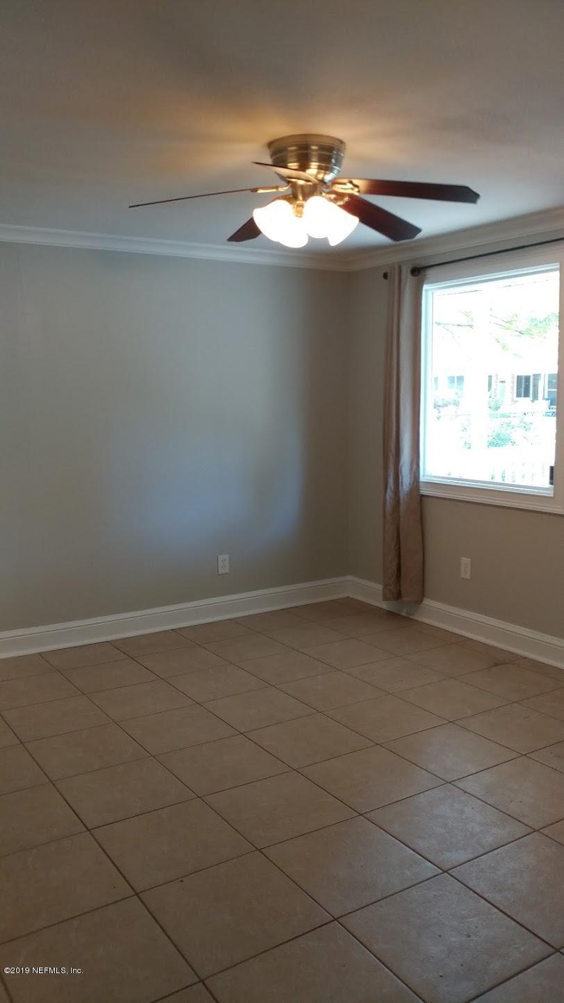 54102 Snyder Road Callahan, FL 32011 - Photo 7 of 14 a view of a decorative ceiling fan and a large window