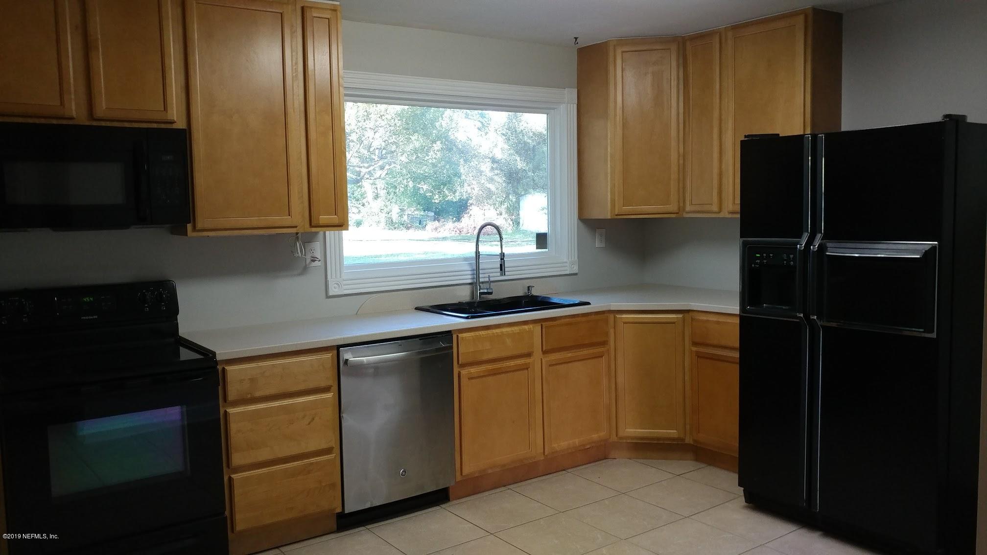 54102 Snyder Road Callahan, FL 32011 - Photo 9 of 14 a kitchen with a refrigerator and a sink