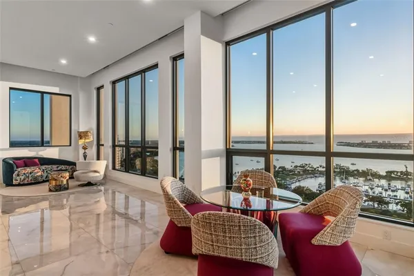 a large kitchen with a table and chairs