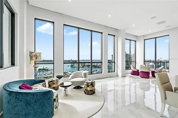 a living room filled with furniture and a floor to ceiling window