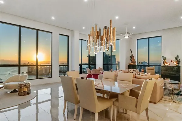 a view of a dining room with furniture water view and wooden floor