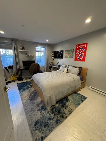 a bathroom with a shower a toilet and a glass door shower