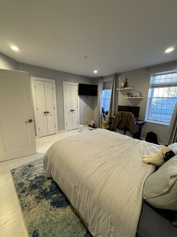 469 Massachusetts Avenue, Unit 1 Boston, MA 02118 - Photo 13 of 33 a spacious bedroom with a bed and a couch
