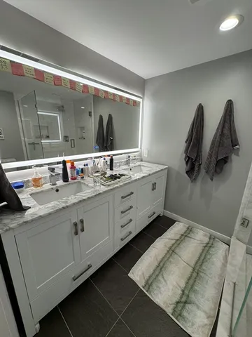 a bathroom with a sink a toilet and a mirror