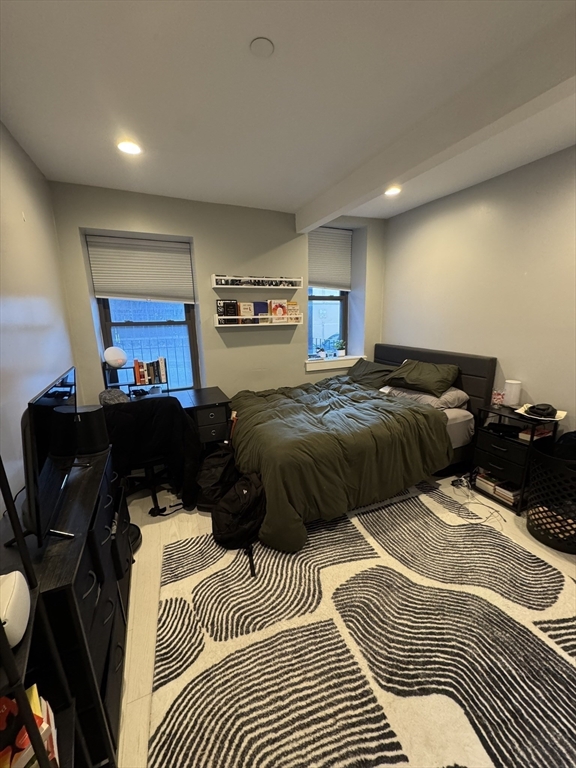 469 Massachusetts Avenue, Unit 1 Boston, MA 02118 - Photo 20 of 33 a bedroom with a bed a lamp and a large window