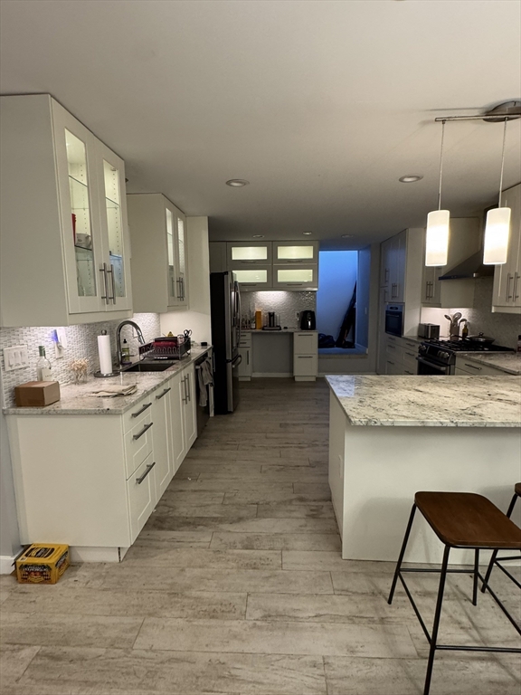 469 Massachusetts Avenue, Unit 1 Boston, MA 02118 - Photo 2 of 33 a kitchen with stainless steel appliances granite countertop a stove a sink and a refrigerator