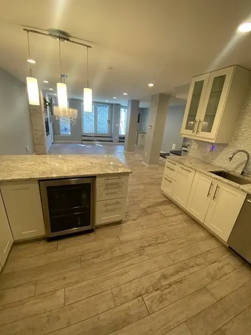 a bathroom with a double vanity sink a toilet and a mirror