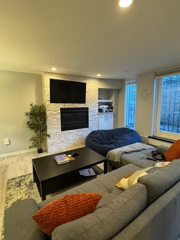 a living room with furniture and a chandelier