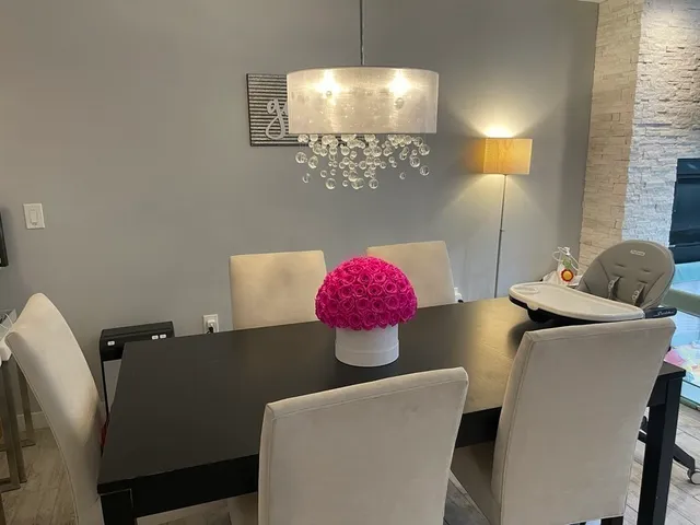 a living room with stainless steel appliances kitchen island a stove and a microwave