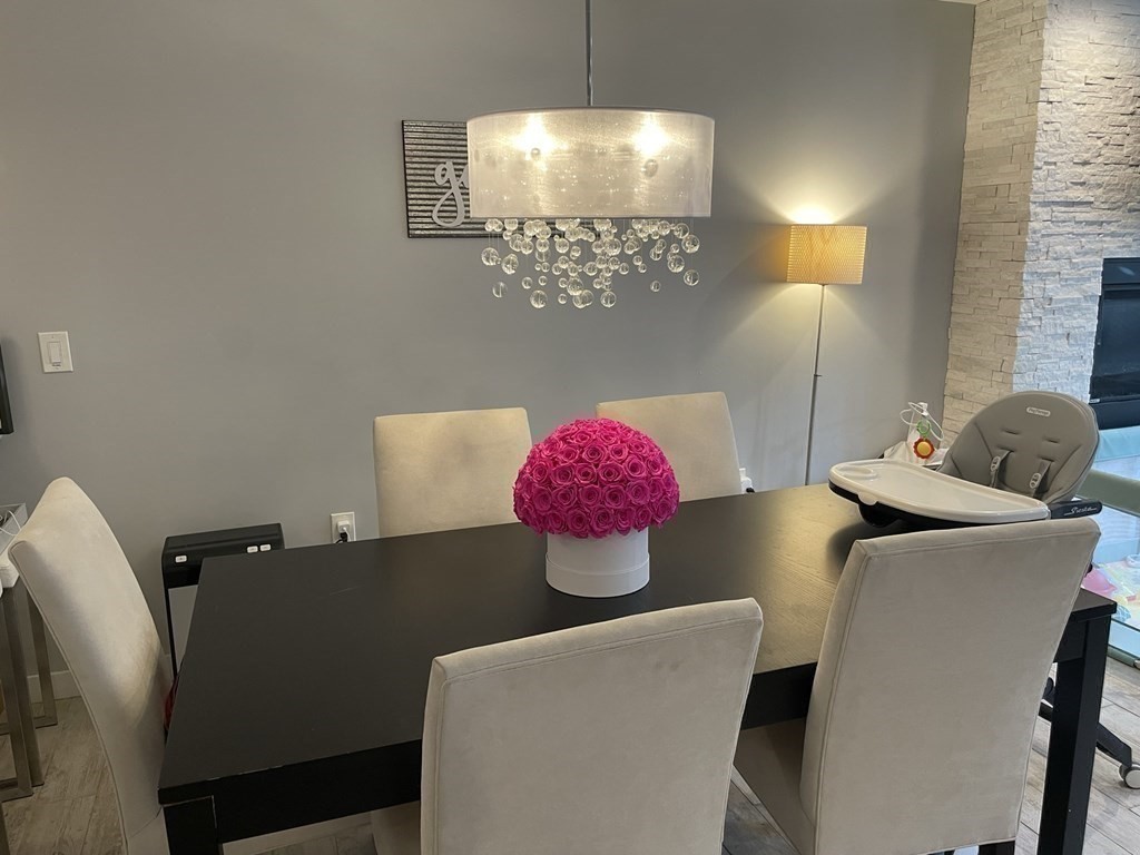 469 Massachusetts Avenue, Unit 1 Boston, MA 02118 - Photo 6 of 33 a living room with furniture and a chandelier