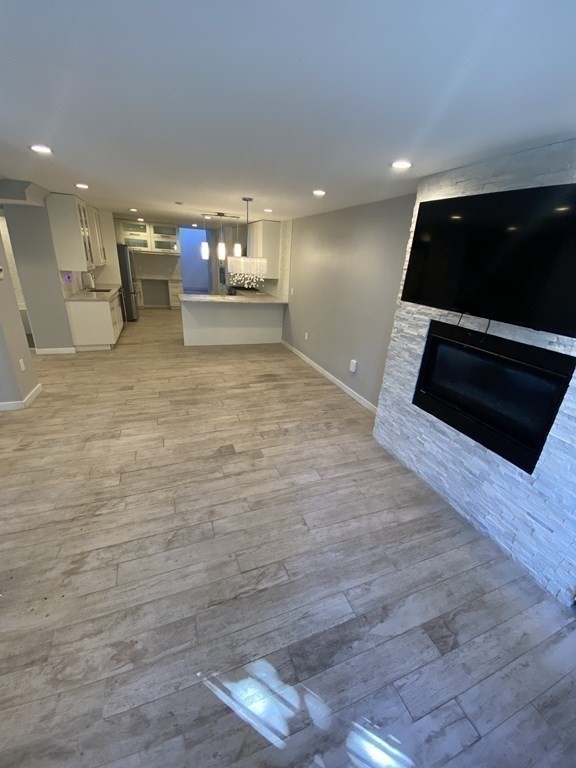 469 Massachusetts Avenue, Unit 1 Boston, MA 02118 - Photo 7 of 33 a living room with stainless steel appliances kitchen island a stove and a microwave