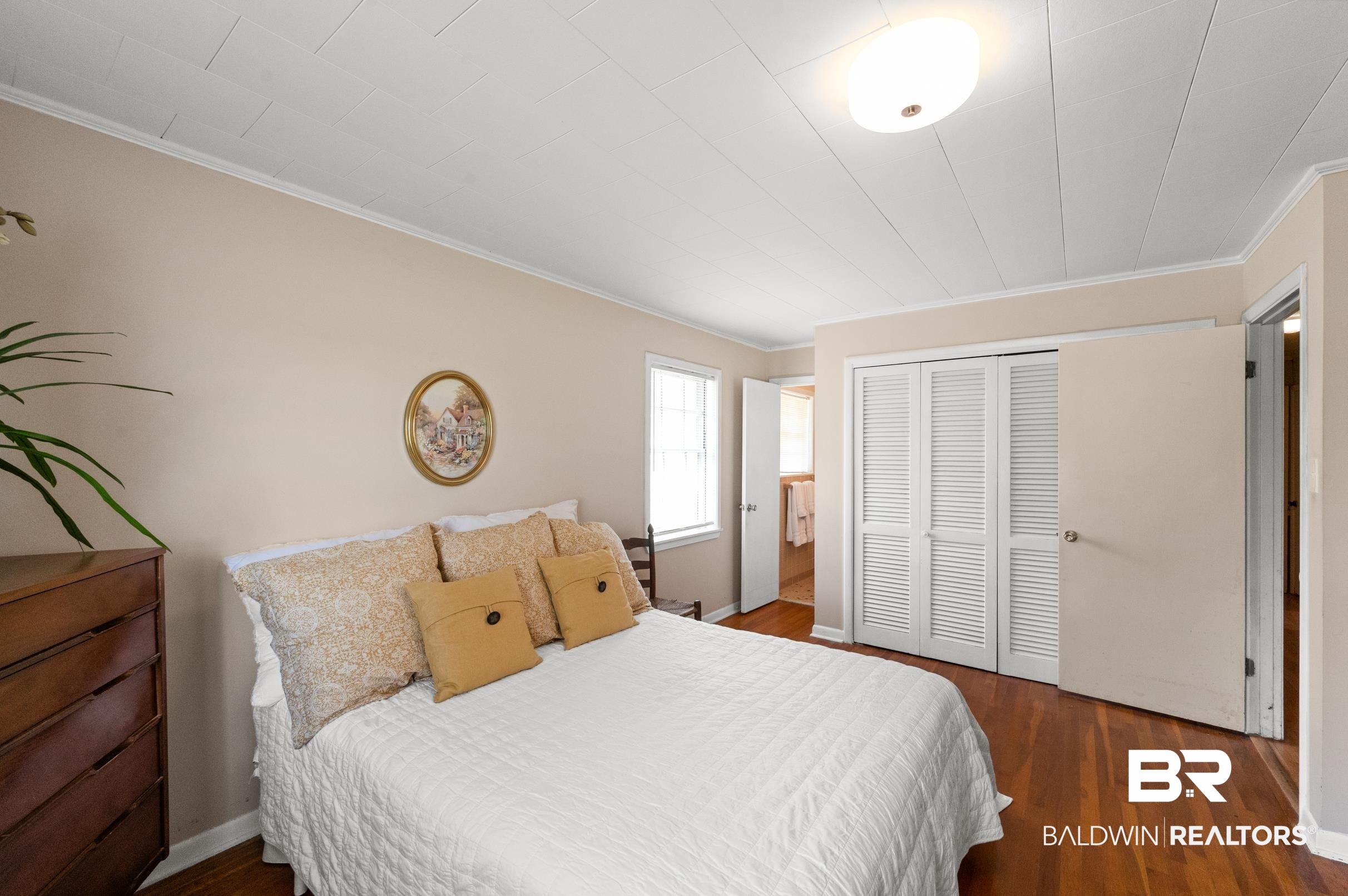 15600 Fackler Road Loxley, AL 36551 - Photo 43 of 51 Bedroom with dark wood-type flooring, ornamental molding, and a closet