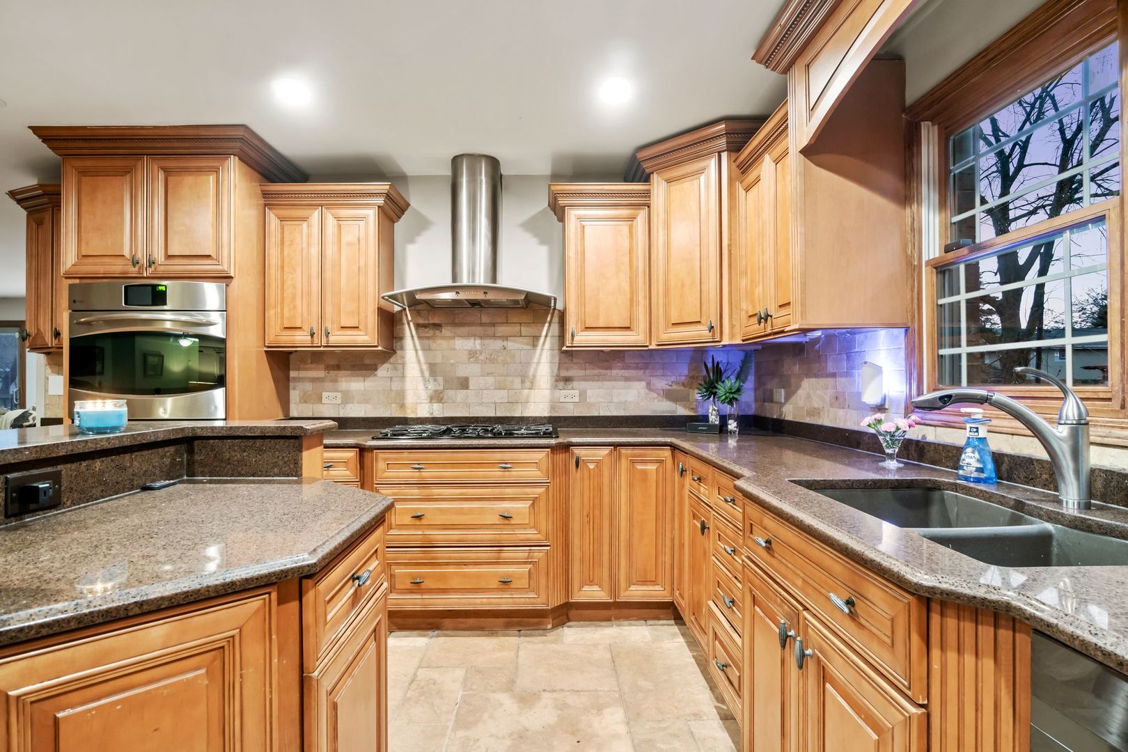 181 Herrick Road Riverside, IL 60546 - Photo 7 of 27 a kitchen with stainless steel appliances granite countertop a sink stove and cabinets