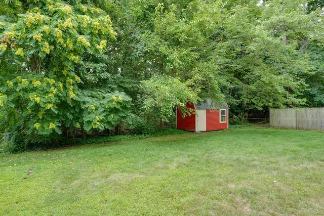 a backyard of a house with oven and swing