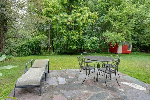 a view of a chairs and table in the garden