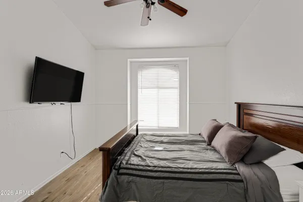 a bedroom with a bed and a flat screen tv
