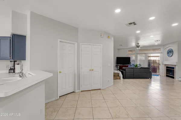 a view of kitchen with sink and refrigerator