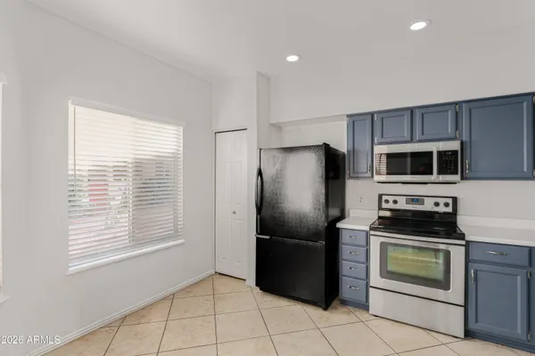 a kitchen with a refrigerator stove and microwave
