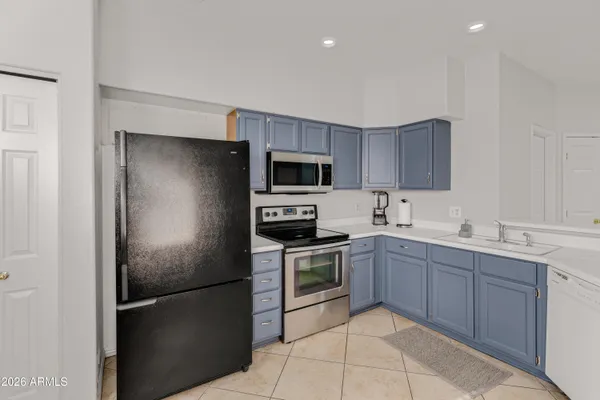 a kitchen with a sink stainless steel appliances and cabinets