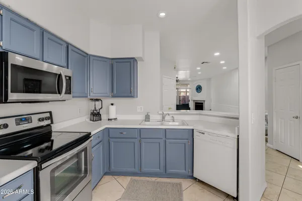 a kitchen with a sink stove and microwave