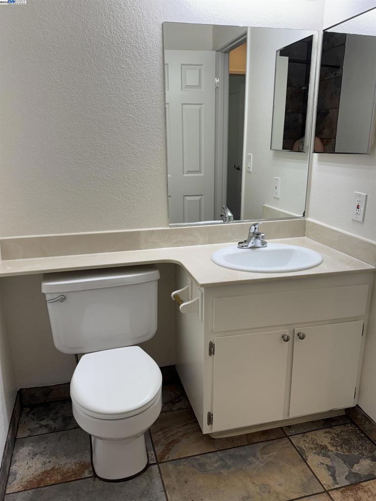 8145 Mountain View Drive Pleasanton, CA 94588 - Photo 11 of 19 a bathroom with a toilet sink and mirror