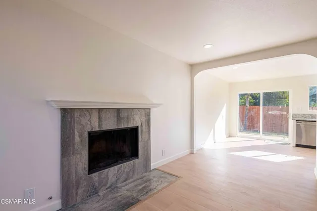 a view of an empty room with a fireplace