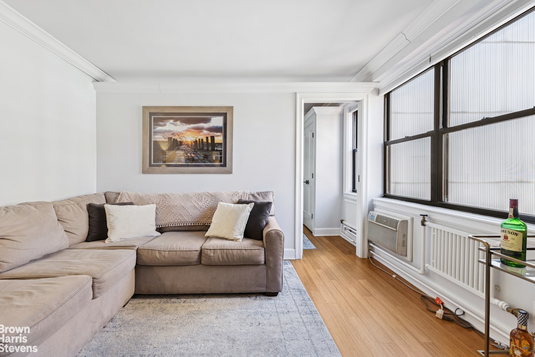 330 3rd Avenue, Unit 10B Manhattan, NY 10010 - Photo 2 of 14 a living room with furniture and a large window