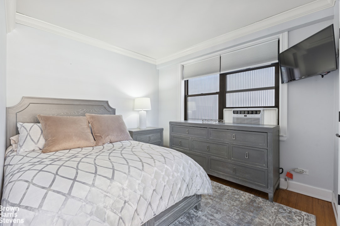 330 3rd Avenue, Unit 10B Manhattan, NY 10010 - Photo 4 of 14 a bedroom with a bed and a flat screen tv