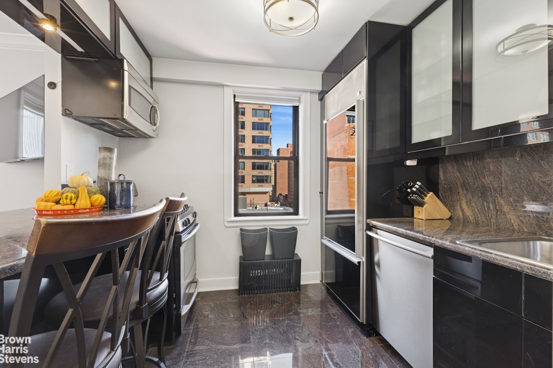 330 3rd Avenue, Unit 10B Manhattan, NY 10010 - Photo 6 of 14 a kitchen with stainless steel appliances granite countertop a stove top oven a sink and dishwasher