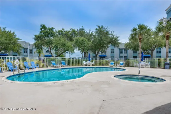 a view of a swimming pool with a yard