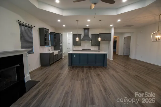 a large kitchen with kitchen island a sink stainless steel appliances and cabinets