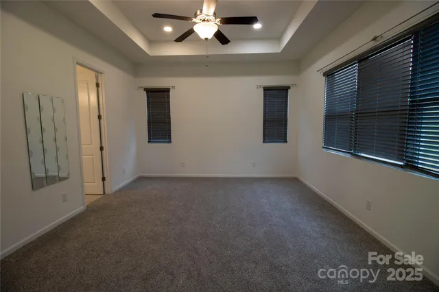 a view of a livingroom with a ceiling fan and window