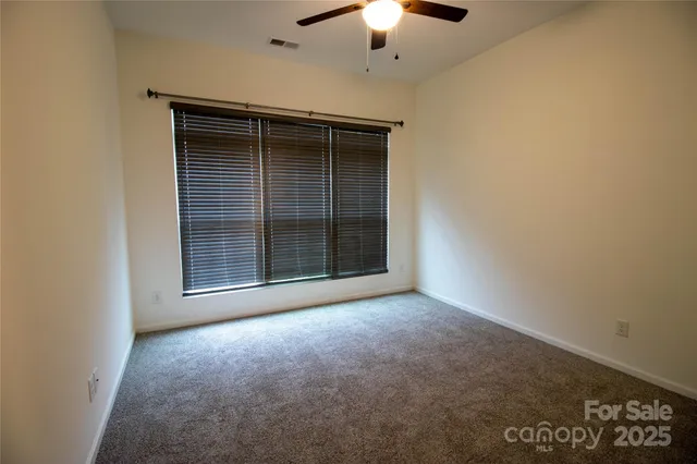 an empty room with a empty space and a ceiling fan