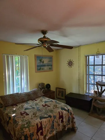 a bedroom with a bed and a couch