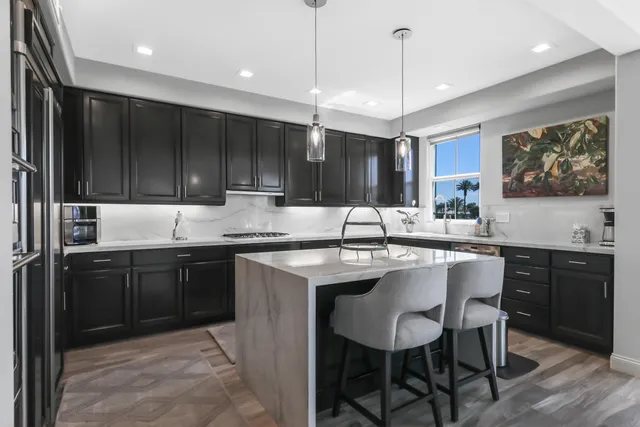 a kitchen with a sink cabinets and wooden floor