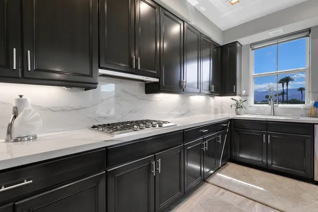 a kitchen with stainless steel appliances granite countertop wooden cabinets and a sink