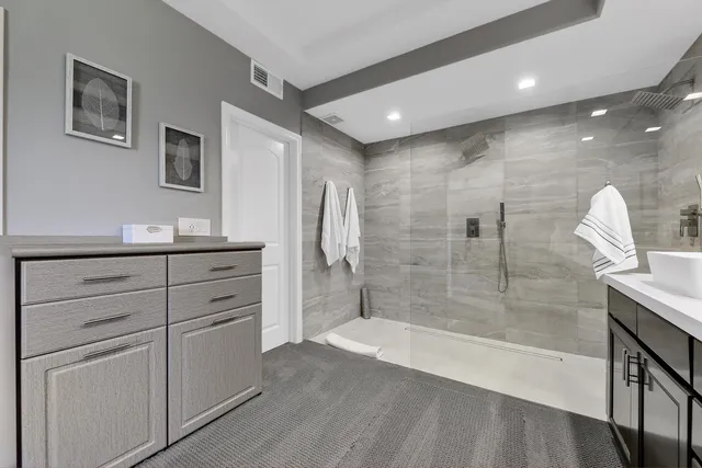 a bathroom with a shower sink and mirror