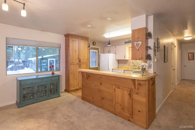 a kitchen with stainless steel appliances granite countertop a sink a stove and cabinets