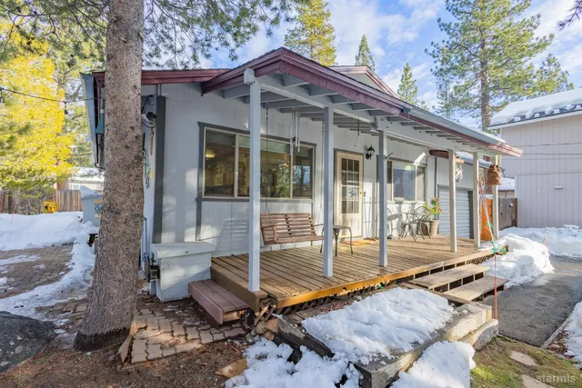 a view of a chair and table in backyard of the house