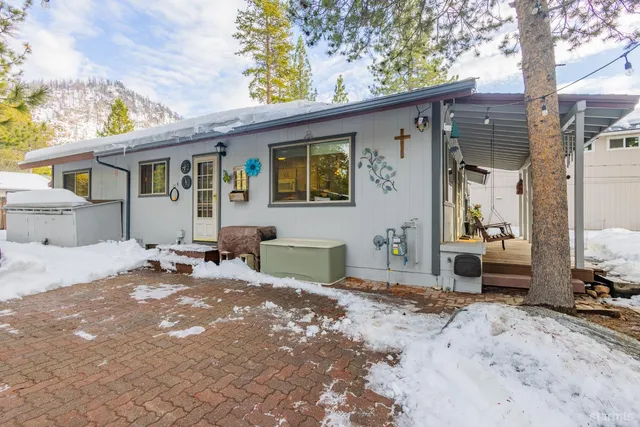 a backyard of a house with barbeque oven table and chairs